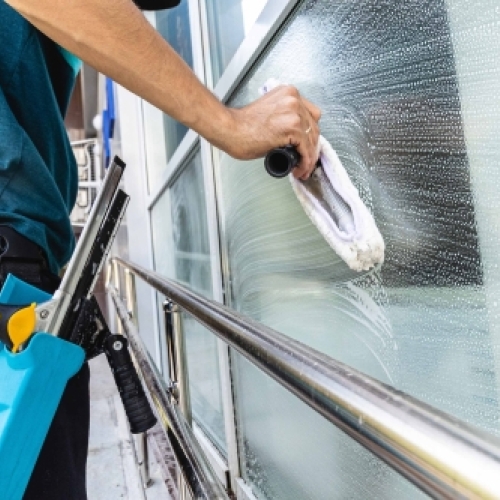 Vinduespudsning med skraber og sæbe